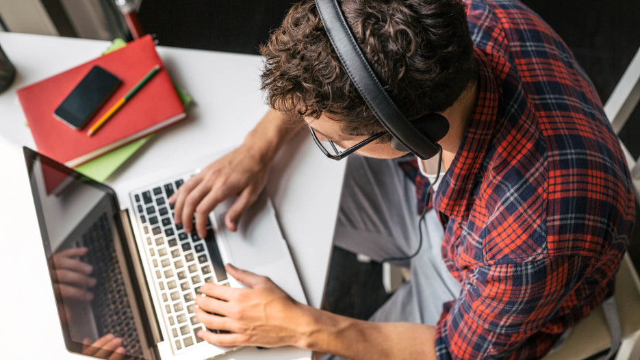 man typing on laptop