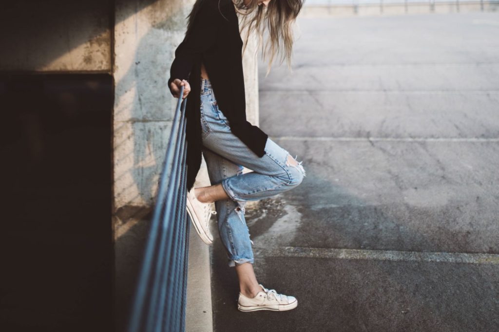 woman standing outside in jeans